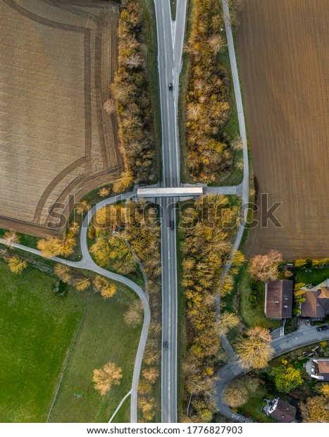 Top\
view from a drone at a street with cars and a\
bridge.