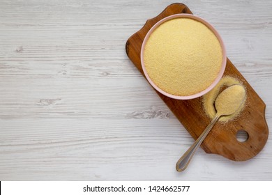 Top View, Dry Semolina Durum Flour In A Pink Bowl Over White Wooden Background. Overhead, From Above, Flat Lay. Copy Space.