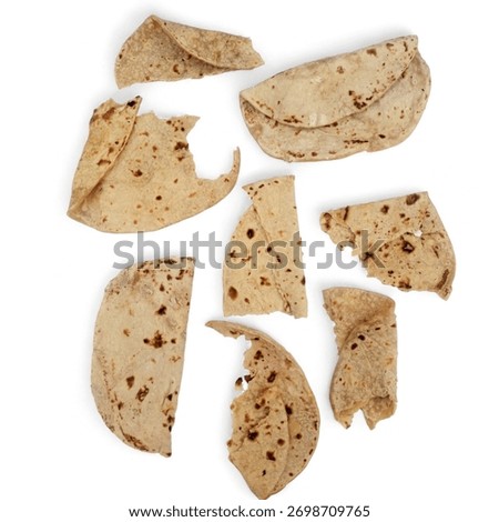 Top view of dry Stale Flatbread or chapati pieces isolated on a white background. Leftover bread top view