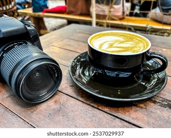 Top view of DSLR camera and creamy coffee latte on wooden table - Powered by Shutterstock