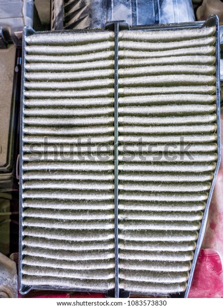 top view of a dusty engine air filter of a modern\
automatic car 