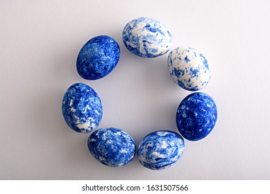 top view Easter eggs in the color the year  classic blue and gradient effect are arranged in circle white background