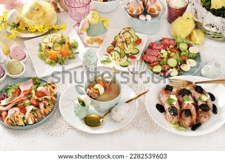 Top view of Easter table with traditional Polish dishes-white borscht, sausage, stuffed eggs and salads