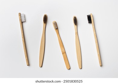 Top view of eco friendly bamboo toothbrushes on grey white, Natural organic personal accessories for tooth care, zero waste, no plastic concept, minimal style aesthetic pattern, set wood toothbrushes - Powered by Shutterstock