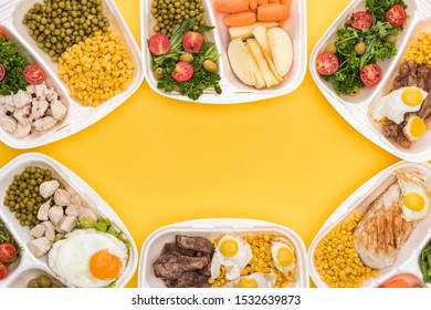 top view of eco packages with apples, vegetables, meat, fried eggs and salads isolated on yellow  - Shutterstock ID 1532639873