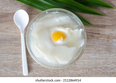 Top View Of Egg And Young Coconut In Coconut Water In A Cup Is A Thai Dessert On Table.