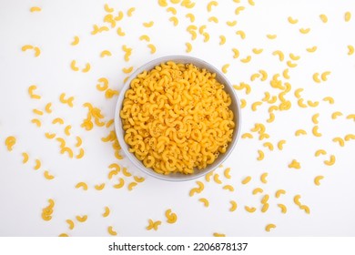 Top view elbow macaroni pasta in a ceramic bowl on top of white background - Powered by Shutterstock