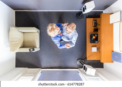 Top View Of An Elderly Couple Dancing To Some Streaming Classical Music In A Small Room