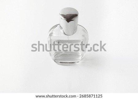 Top view of an elegant empty perfume bottle isolated on a white surface. Ideal for product branding, mockups, cosmetic ads, or minimalist stock design concepts.