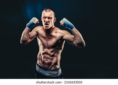 Top view of emotional Boxer who celebrates win on dark background. Sports banner. 