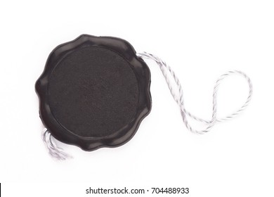 Top View Of Empty Black Wax Plastic Seal Swing Tag With Fiber Thread And Copyspace Isolated On White Background