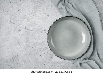 Top view of empty bowl on grey stone table. Minimalist food background for culinary blog, social media posts, cafe branding. Top view.