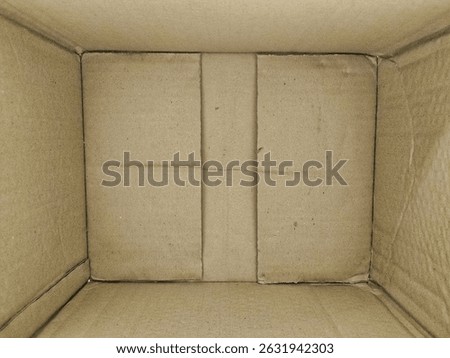 Top view of an empty brown cardboard box showing texture and creases inside.