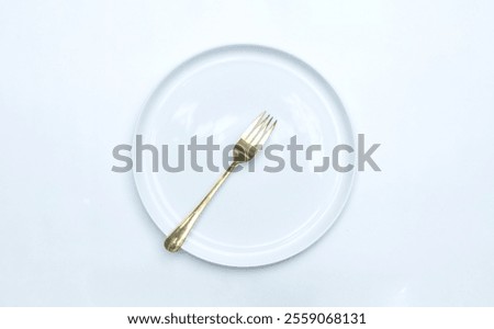 Top view empty ceramic plate and a fork on it