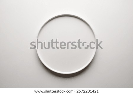 Top view of empty ceramic white plate on white background