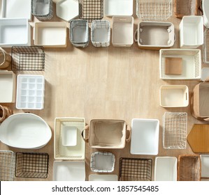 Top View Of Empty Closet Organization Boxes And Steel Wire Baskets In Different Shape Placed On White Marble Table With Copy Space. Marie Kondo’s Hikidashi Boxes For Tidying Clothes And Drawer Storage