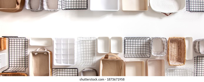 Top View Of Empty Closet Organization Boxes And Steel Wire Baskets In Different Shape Placed On White Marble Table With Copy Space. Marie Kondo’s Hikidashi Boxes For Tidying Clothes And Drawer Storage