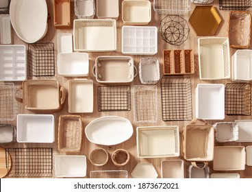 Top View Of Empty Closet Organization Boxes And Steel Wire Baskets In Different Shape Placed On White Marble Table With Copy Space. Marie Kondo’s Hikidashi Boxes For Tidying Clothes And Drawer Storage