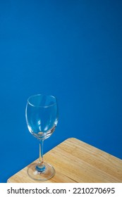 Top View Of Empty Glasses On A Wooden Board With A Blue Background, Wine Glasses, Dinner And Party Concept.