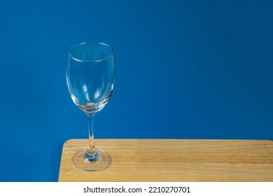 Top View Of Empty Glasses On A Wooden Board With A Blue Background, Wine Glasses, Dinner And Party Concept.