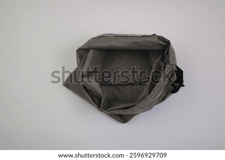 Top View of an Empty Gray Fabric Drawstring Bag on White Background