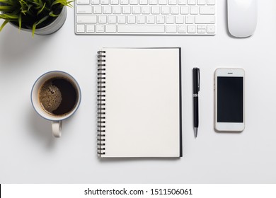 Top view, empty notebook and office supplies on the desk.