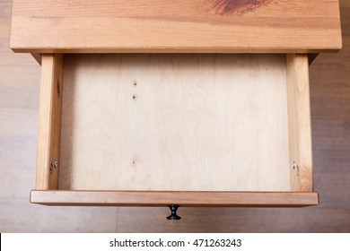 Top View Of Empty Open Drawer Of Nightstand