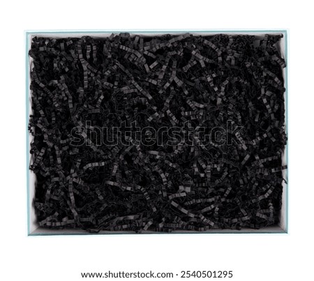 Top view of empty open gift box with black color shredded paper - gift box filler. Luxury present wrapping or products background. Isolated on white, studio shot.