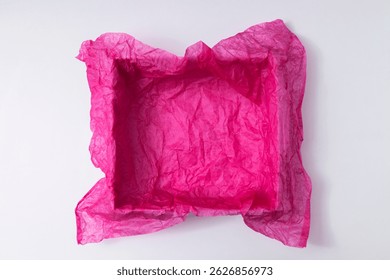 Top view of empty present box and crumpled pink tissue paper for packaging, white background. Space for design or product
