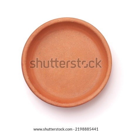 Top view of empty round clay baking pan isolated on white