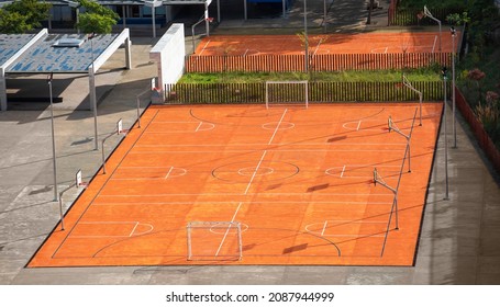 Top View Of Empty School Playground. Schoolyard Without Children. Orange Outdoor Football And Basketball Courts