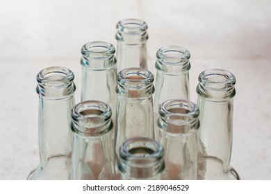 Top View Of Empty Soft Drinks Glass Bottles On The Floor. Close Up. Recycled Glass Concept.