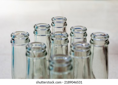 Top View Of Empty Soft Drinks Glass Bottles On The Floor. Close Up. Recycled Glass Concept.