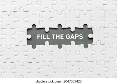 Top view of an empty space of jigsaw puzzle fill with a phrase Fill The Gaps.