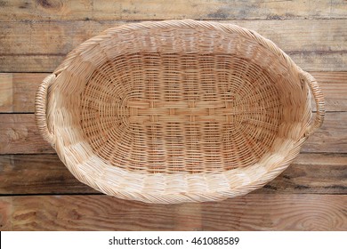 Top View Of An Empty Wicker Basket On Old Wooden Floor.