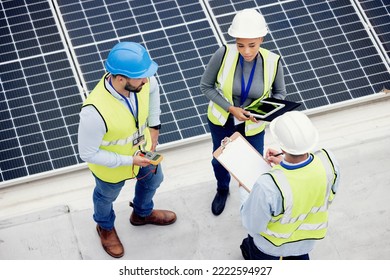 Top view, engineer teamwork and planning of solar panel maintenance, inspection or installation. Solar energy, renewable energy and group of contractors with tablet, tech or checklist in discussion. - Powered by Shutterstock