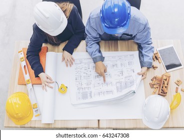 Top View Engineer And Workers Discussing Project Of New Building. ,Team Of Architects Asian People In Group On Construction Site Check Documents And Business Workflow.,teamwork Concept