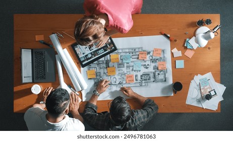 Top view of engineer working together to design building construction while standing at meeting table with blueprint and notes. Top view of interior designer choosing color from palettes. Symposium. - Powered by Shutterstock