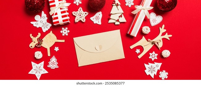 Top view of envelope on red background. New Year decorations. Christmas holiday concept. - Powered by Shutterstock