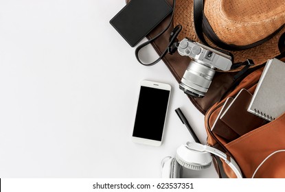 Top view of essential modern. travel accessories on white wooden table background. over light  - Powered by Shutterstock