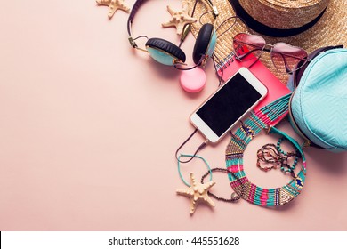  Top view of essential modern young lady or girl on vacations.Woman's summer holidays accessories composed on pastel color background. Beach fashion , summer concept. Trendy colors.