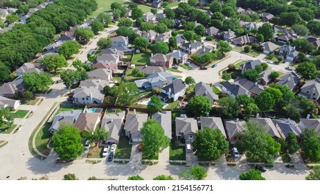 Top view an established neighborhood with matured trees and two story houses in Flower Mound, Texas, US. Upscale parkside Dallas suburbs single family homes with large backyard lush green - Shutterstock ID 2154156771