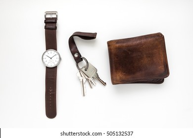 Top view of everyday carry objects made by brown leather on white background