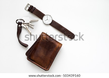 Top view of everyday carry objects made by brown leather on white background
