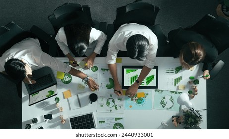 Top view of executive manager hold tablet display clean energy at meeting. Aerial view of business people working together to plan and invest in sustainable environmental investment. Alimentation. - Powered by Shutterstock