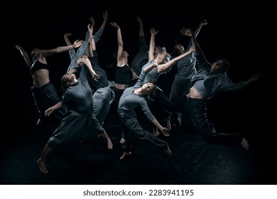 Top view. Expressive contemp dance. Group of young people dancing against black studio background. Concept of modern freestyle dance, contemporary art, movements, hobby and creative lifestyle - Powered by Shutterstock