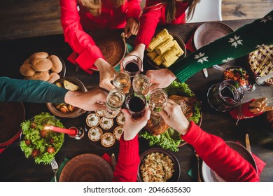 Top view of family celebrating winter holidays together drinking champagne at festive table
