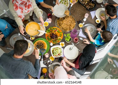 Top view of family and friends eating food on table