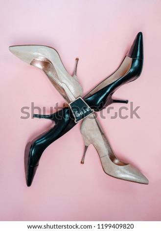 top view fashion female high heels shoes, beige golden pink and black colors with sign sale isolated against a light pink background. Black Friday sale shopping concept. Flat lay, top view, vertical