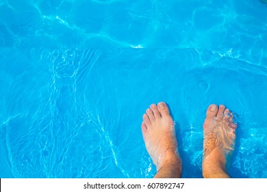 Top View Of Feet On Pool